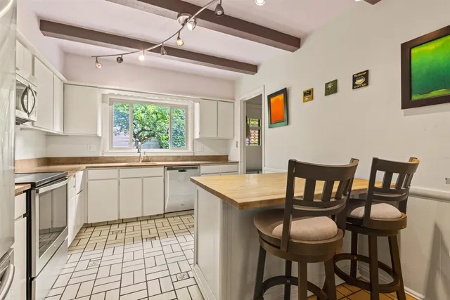 a kitchen with a dining table and chairs