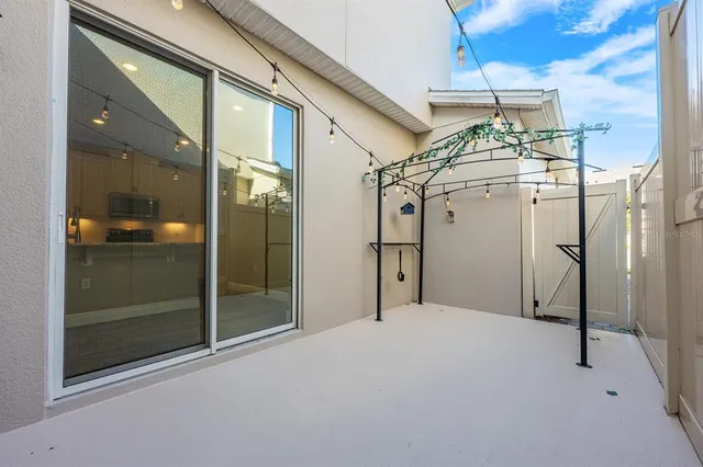 a very nice looking room with a glass door and chandelier
