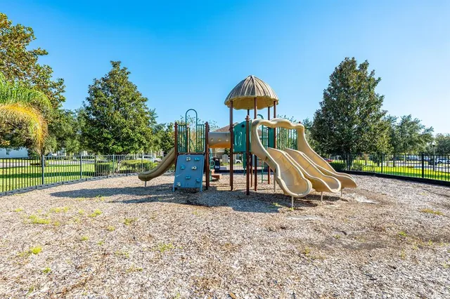 a view of outdoor space with playground and green space
