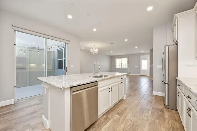 a large bathroom with a granite countertop sink a large mirror and a shower