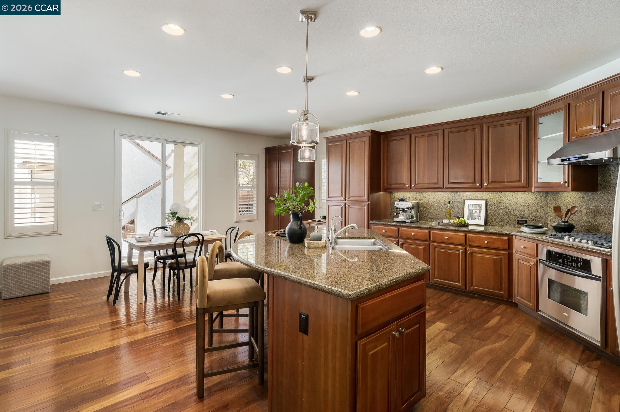 2359 Magnolia Bridge Drive San Ramon, CA 94582 - Photo 8 of 44 a kitchen with sink cabinets dining table and chairs