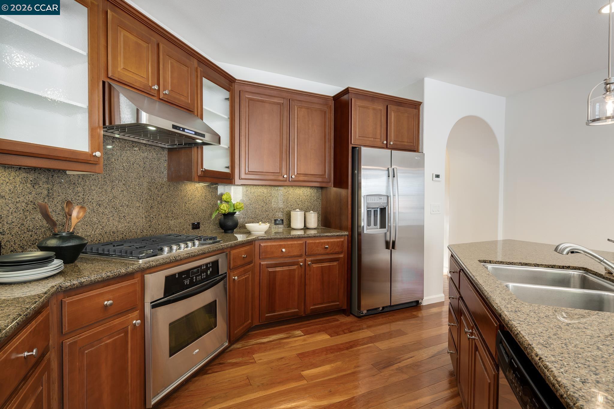 2359 Magnolia Bridge Drive San Ramon, CA 94582 - Photo 10 of 44 a kitchen with stainless steel appliances granite countertop a sink stove and refrigerator