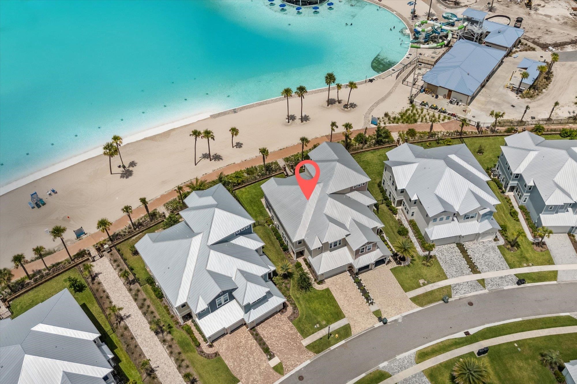 an aerial view of a house with outdoor space and a lake view