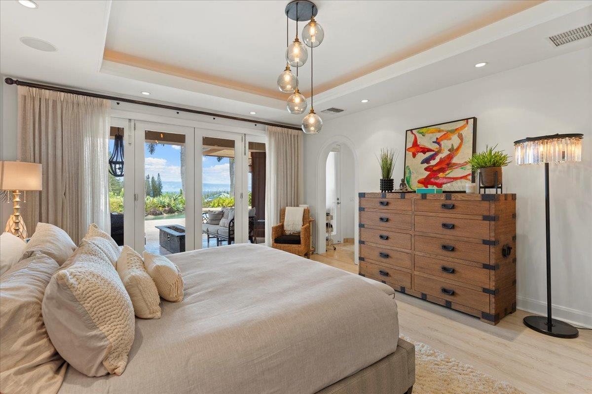 238 Crestview Road Lahaina, HI 96761 - Photo 25 of 48 a bedroom with a bed and a chandelier
