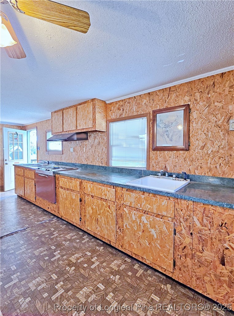 764 Old Vander Road Fayetteville, NC 28312 - Photo 36 of 50 a view of a kitchen with kitchen island granite countertop a sink and wooden cabinets