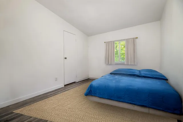 a bedroom with a bed and window