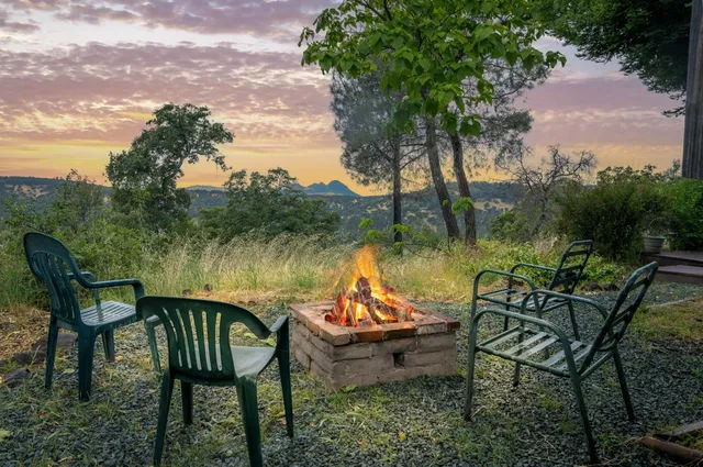 a view of a lake with table and chairs