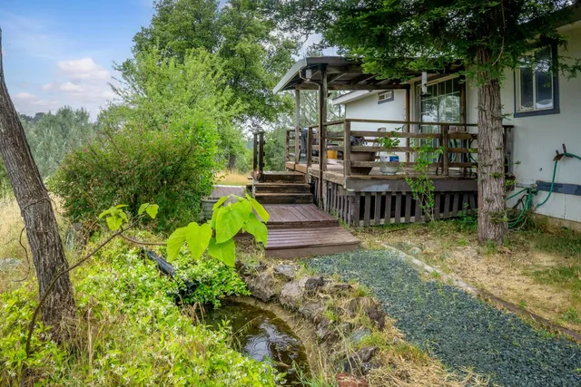 a view of a house with backyard and sitting area