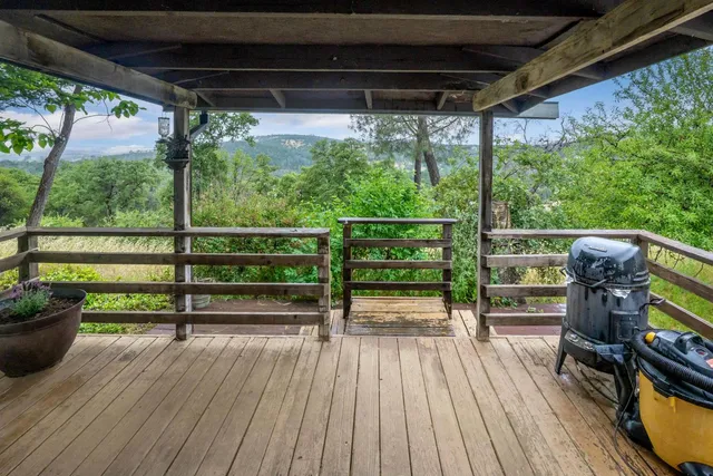 a view of porch with a table and a chairs