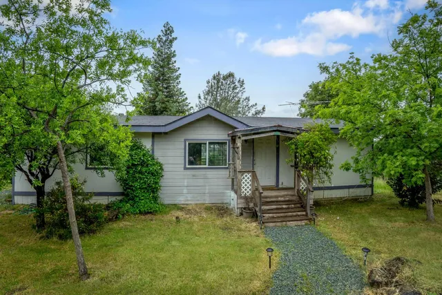 a front view of a house with a garden