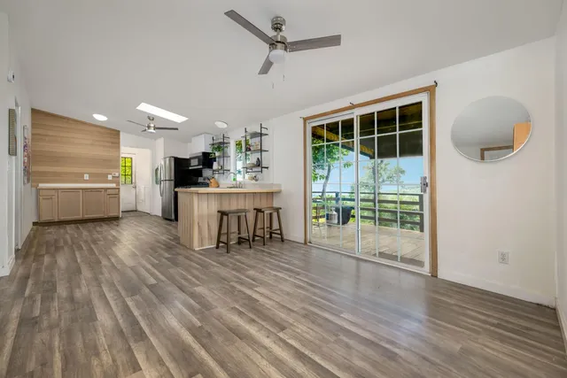 a room with wooden floor and windows