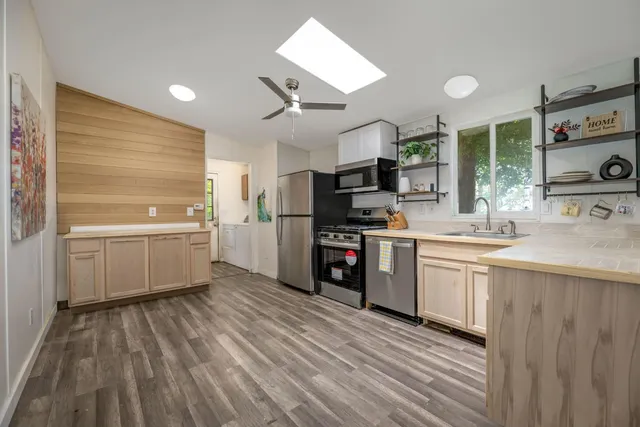 a kitchen with stove cabinets and refrigerator