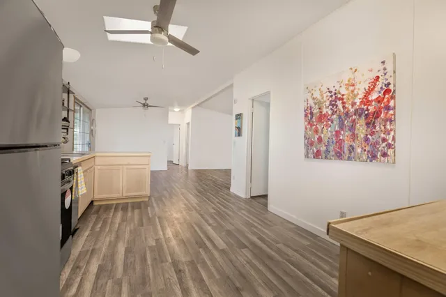 a view of a room with wooden floor and white walls