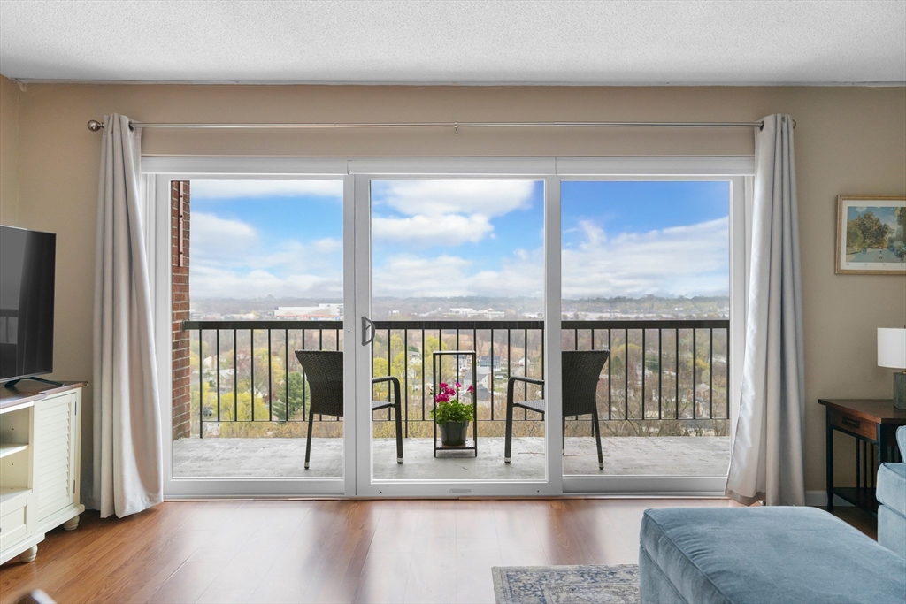a view of a living room hardwood floor and a large window