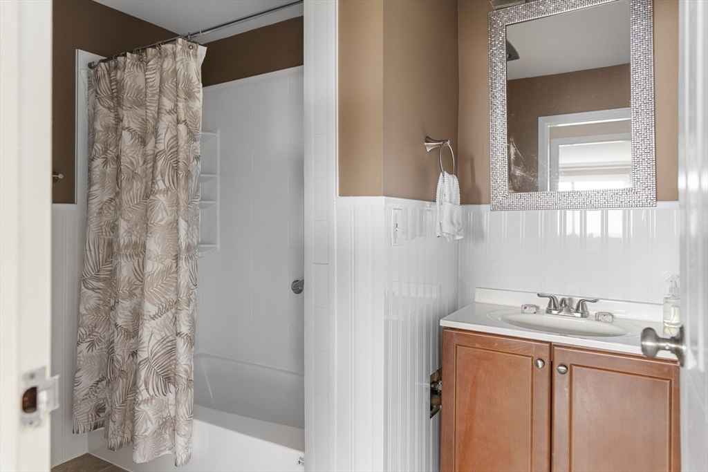 3 Summit Drive, Unit 67 Reading, MA 01867 - Photo 11 of 17 a bathroom with a sink and a mirror