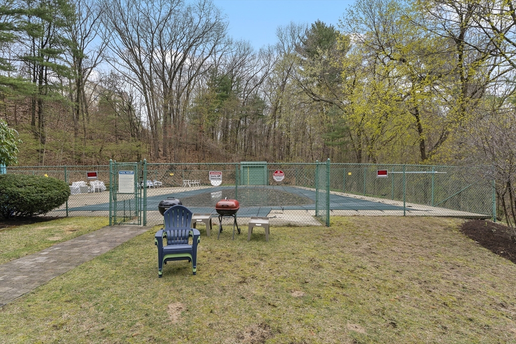 3 Summit Drive, Unit 67 Reading, MA 01867 - Photo 15 of 17 a view of a bench in a backyard