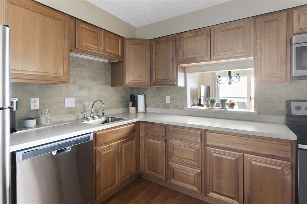 3 Summit Drive, Unit 67 Reading, MA 01867 - Photo 7 of 17 a kitchen with sink cabinets and a window