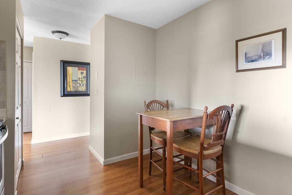 3 Summit Drive, Unit 67 Reading, MA 01867 - Photo 8 of 17 a dining room with furniture and wooden floor