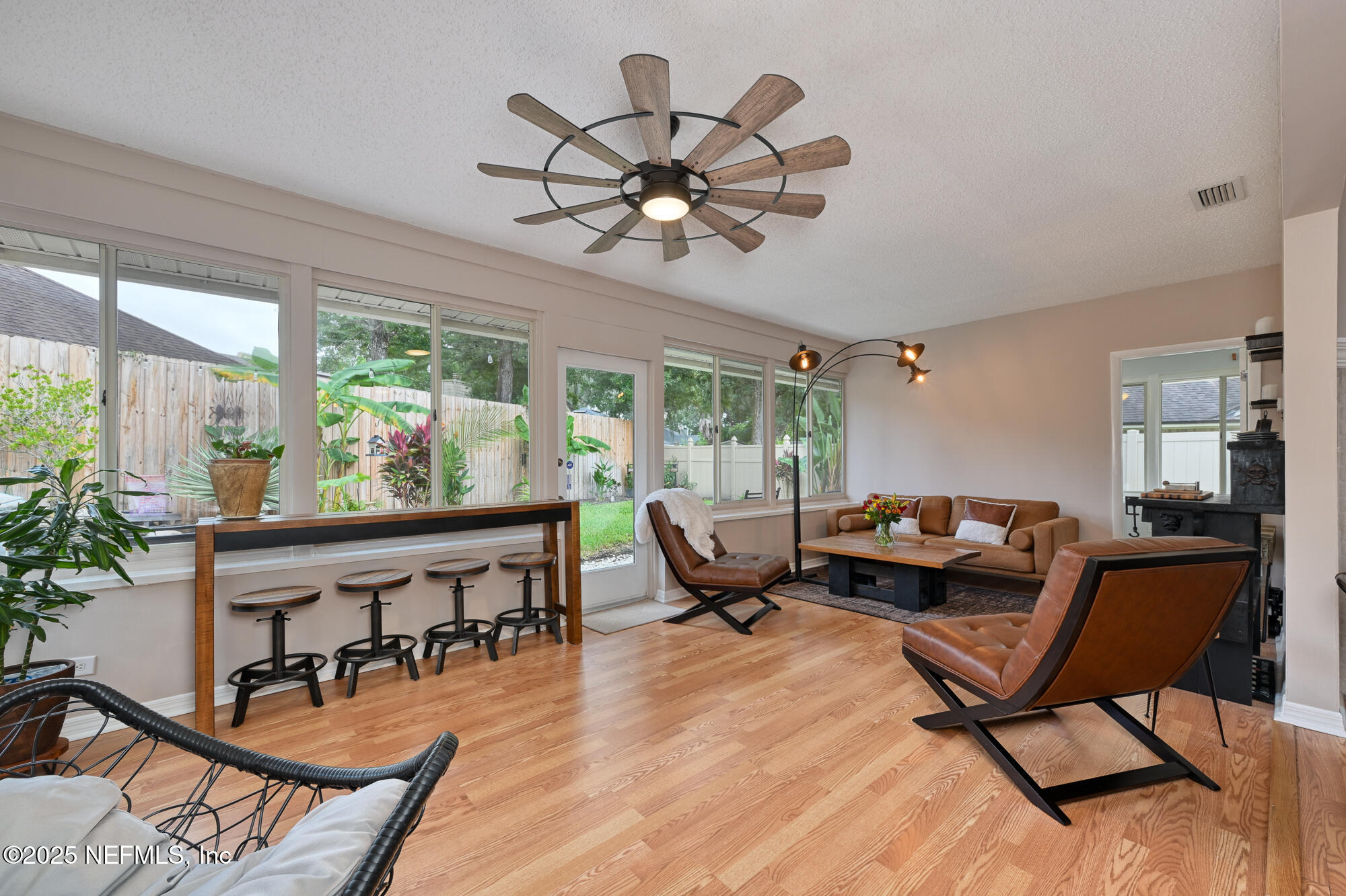 10905 Brentfield Road Jacksonville, FL 32225 - Photo 11 of 36 a living room with furniture a window and a chandelier