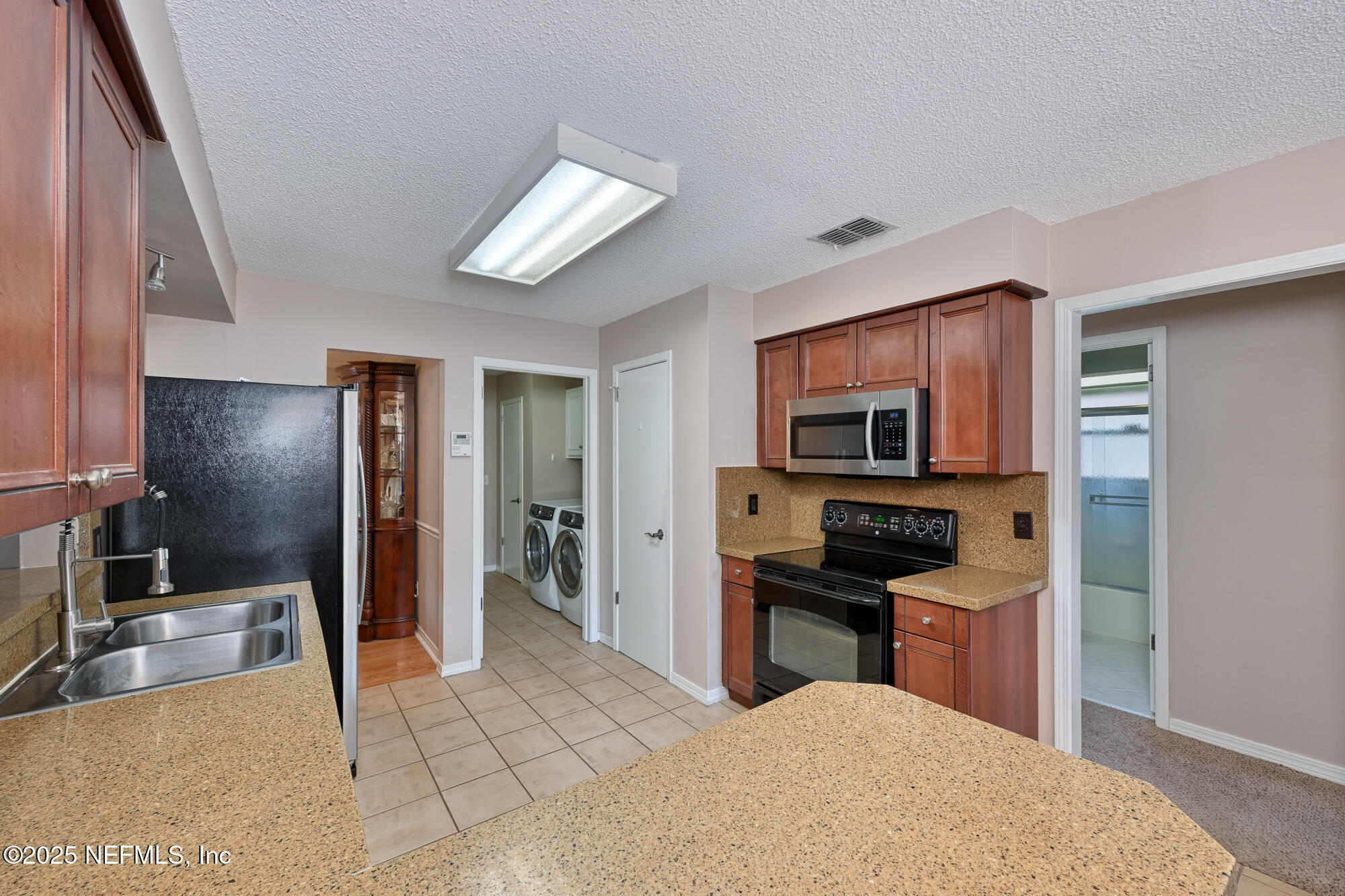 10905 Brentfield Road Jacksonville, FL 32225 - Photo 15 of 36 a kitchen with stainless steel appliances granite countertop a refrigerator and a sink