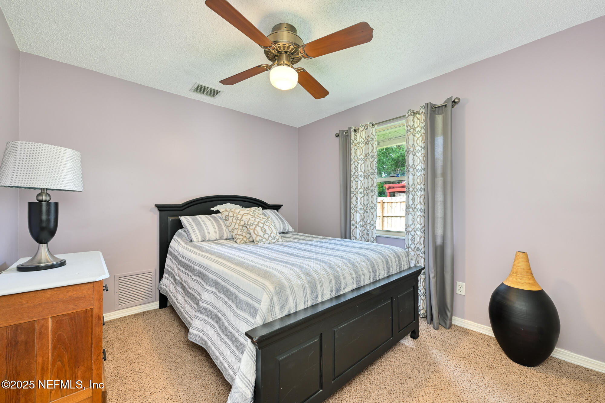 10905 Brentfield Road Jacksonville, FL 32225 - Photo 24 of 36 a bedroom with a bed and window