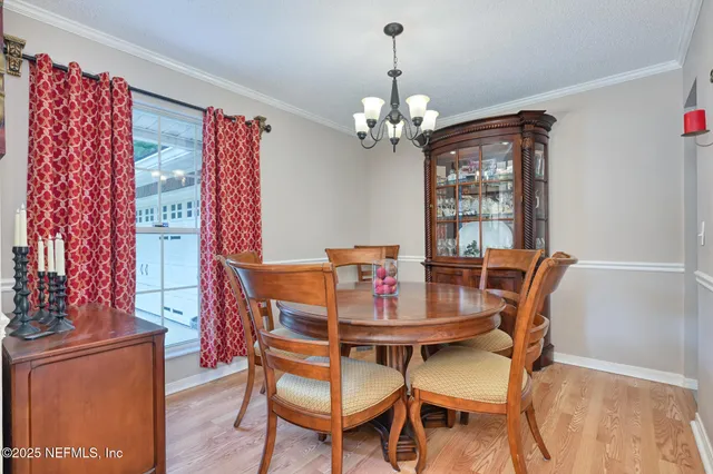 a view of a dining room with furniture and chandelier