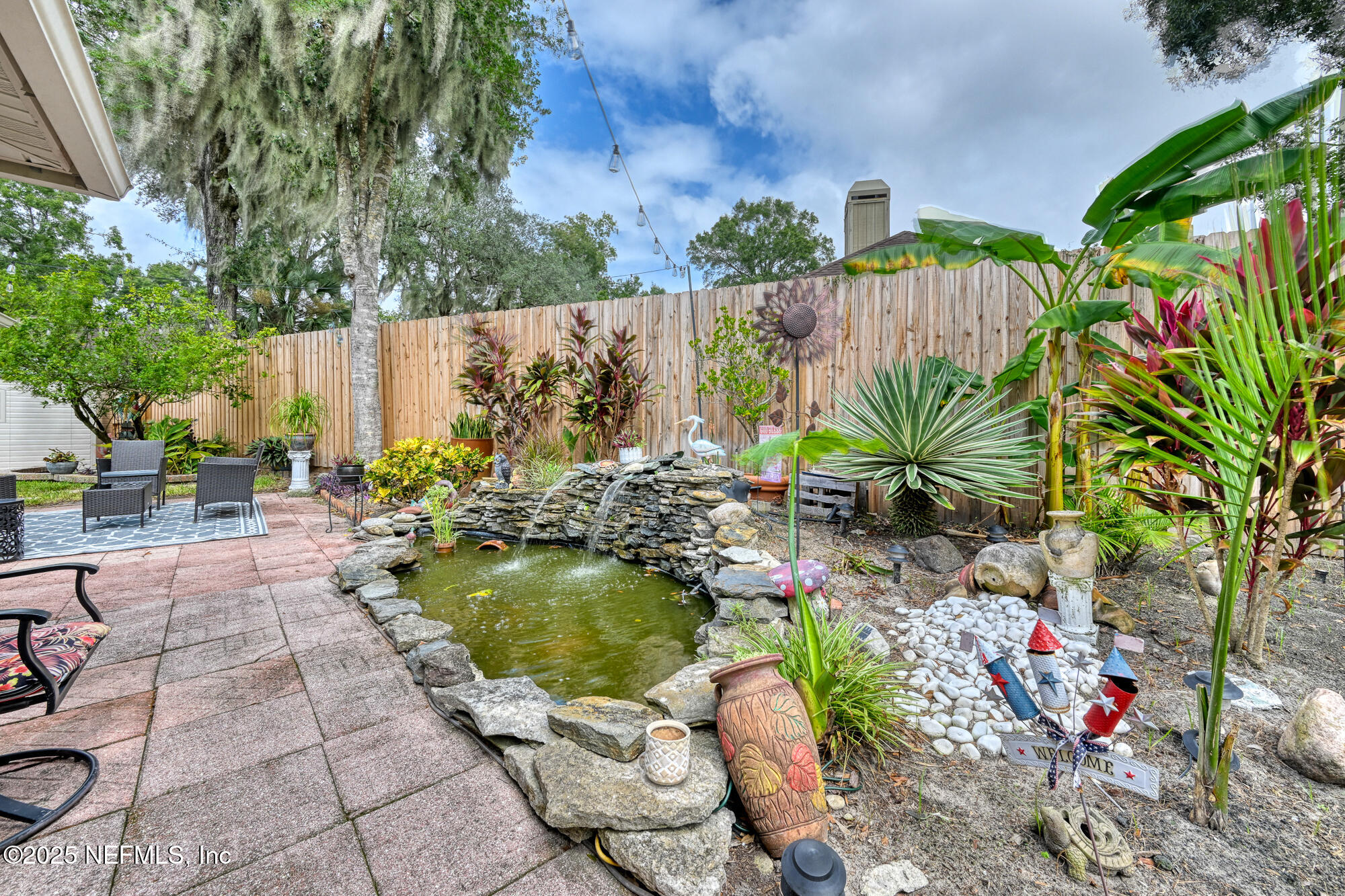 10905 Brentfield Road Jacksonville, FL 32225 - Photo 33 of 36 a view of a backyard with plants and chairs