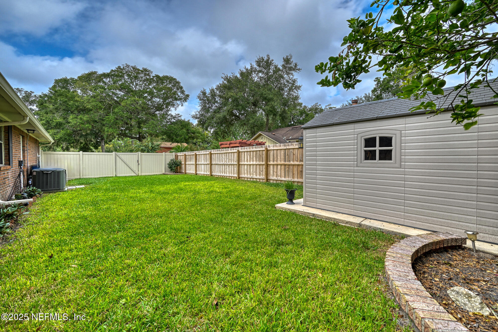 10905 Brentfield Road Jacksonville, FL 32225 - Photo 35 of 36 a view of a backyard with a small cabin