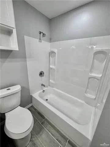 a bathroom with a toilet and a bathtub