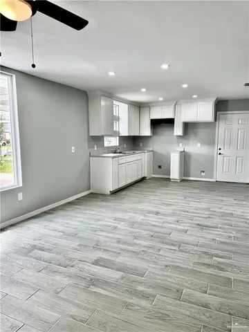 a large kitchen with kitchen island a sink stainless steel appliances and cabinets