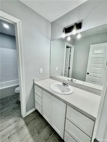 a bathroom with a double vanity sink and mirror