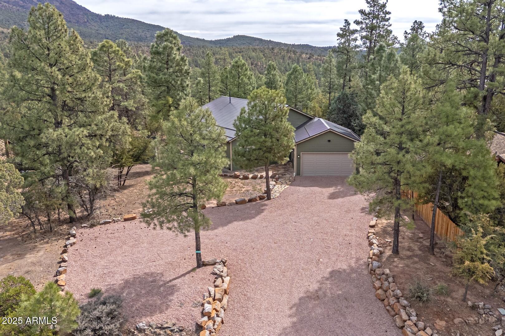 a view of a house with a yard and mountain