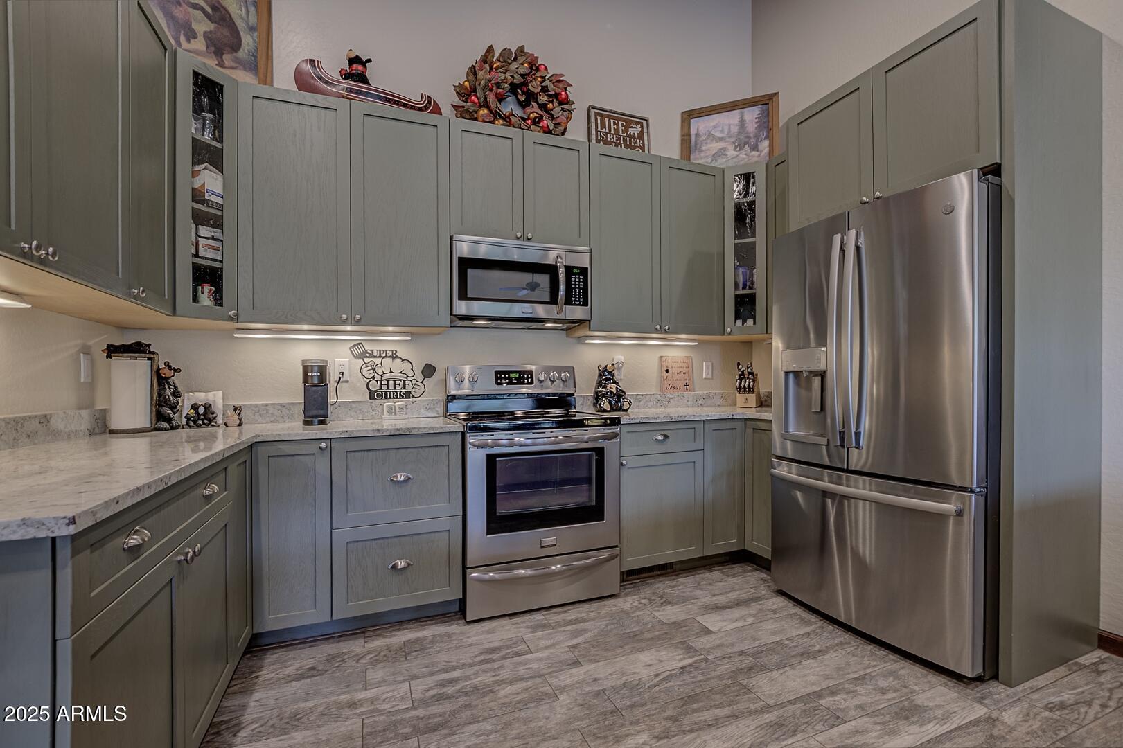 3465 Whispering Pines Road Pine, AZ 85544 - Photo 11 of 53 a kitchen with a refrigerator stove and sink