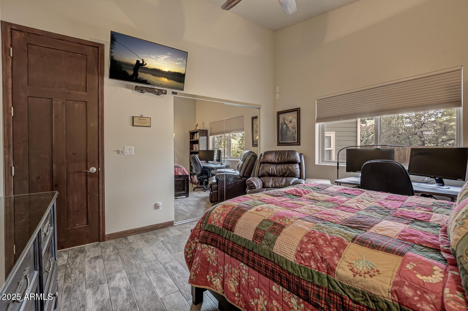 3465 Whispering Pines Road Pine, AZ 85544 - Photo 21 of 53 a bed room with a bed a television and a large mirror