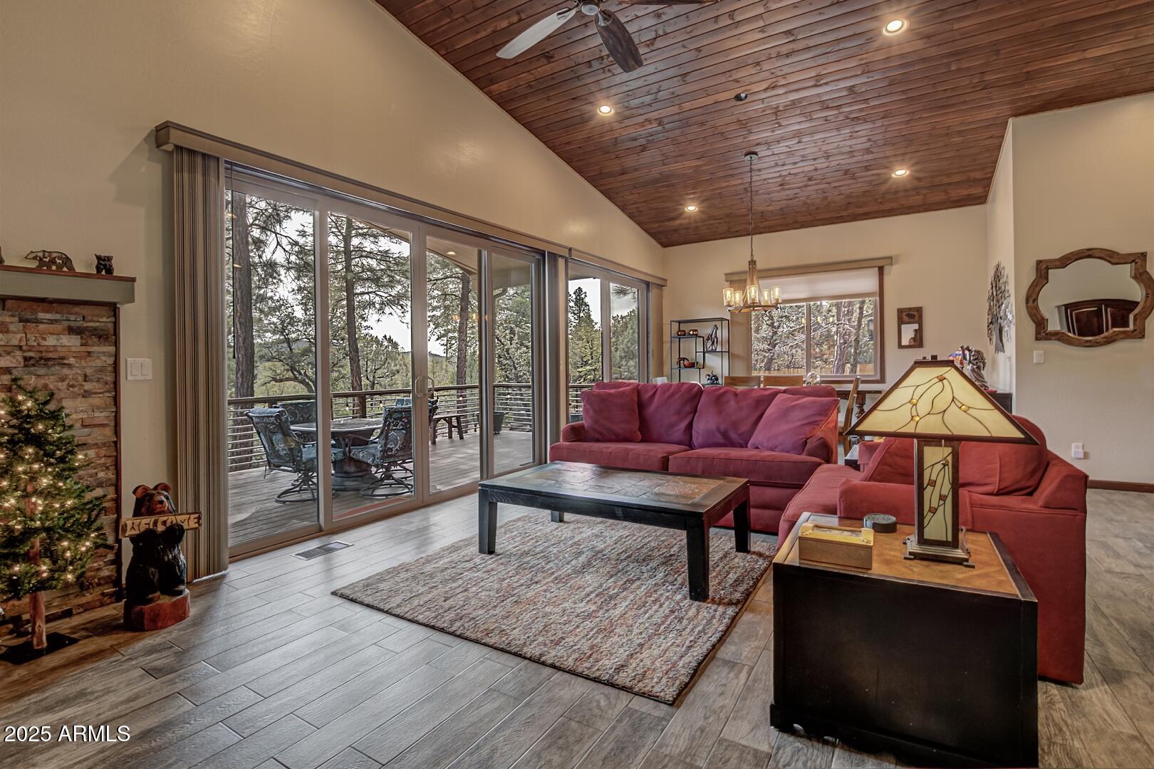 3465 Whispering Pines Road Pine, AZ 85544 - Photo 3 of 53 a living room with furniture a table and wooden floor