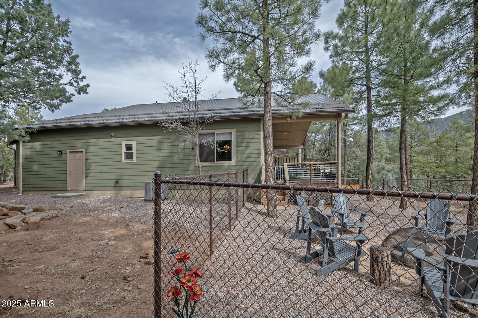 3465 Whispering Pines Road Pine, AZ 85544 - Photo 36 of 53 front view of a house with a bench
