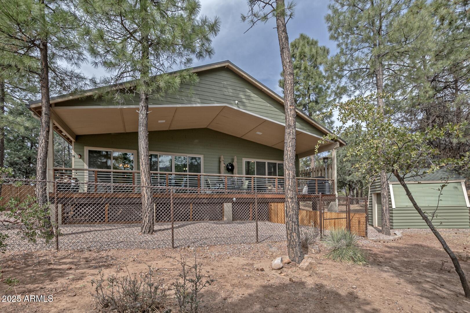 3465 Whispering Pines Road Pine, AZ 85544 - Photo 37 of 53 a front view of a house with a yard