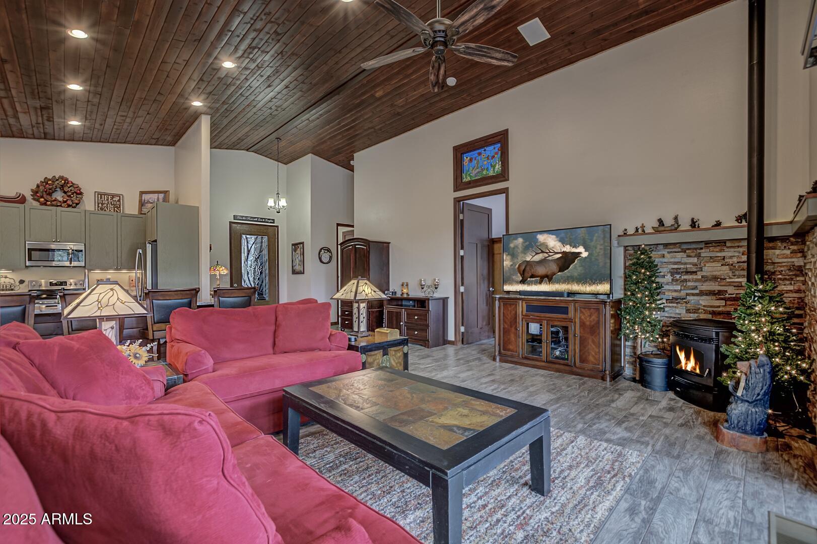 3465 Whispering Pines Road Pine, AZ 85544 - Photo 4 of 53 a living room with furniture a flat screen tv and a fireplace