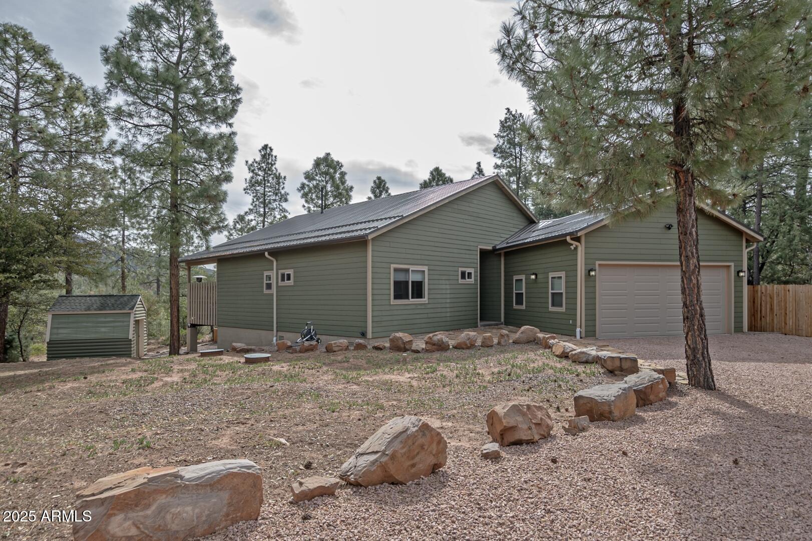 3465 Whispering Pines Road Pine, AZ 85544 - Photo 42 of 53 a backyard of a house with table and chairs