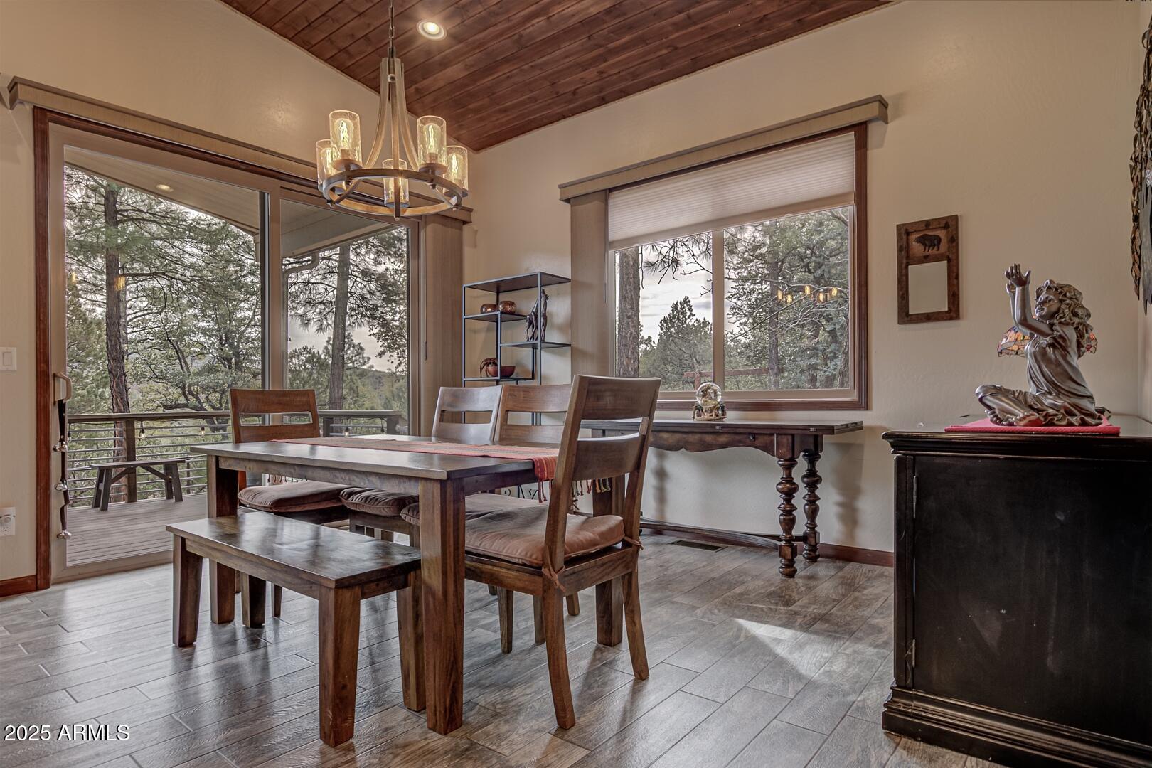 3465 Whispering Pines Road Pine, AZ 85544 - Photo 7 of 53 a view of a dining room with furniture window and wooden floor