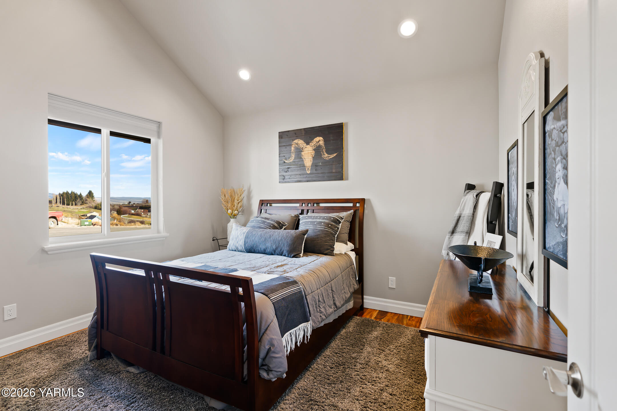455 Rankin Road Selah, WA 98942 - Photo 25 of 57 a bedroom with a bed and a flat tv screen on the dresser