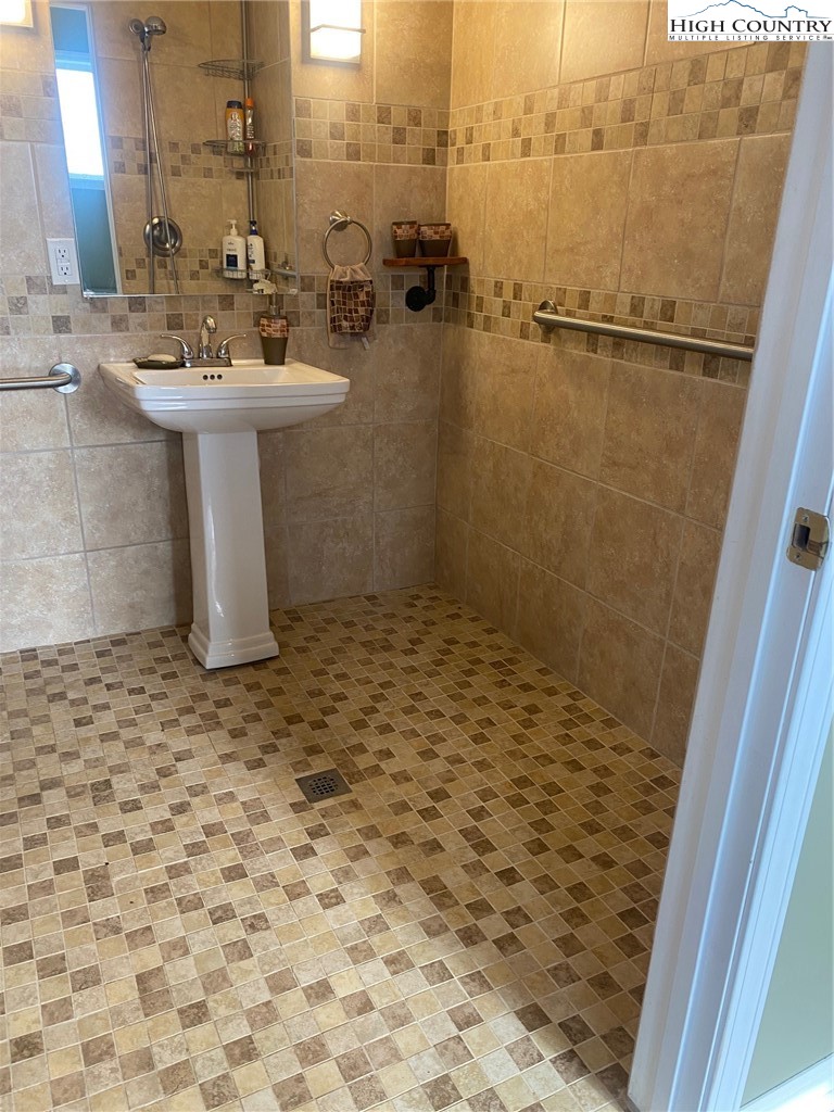 1345 Wagoner Ridge Road Ennice, NC 28623 - Photo 12 of 48 a bathroom with a sink a toilet and shower