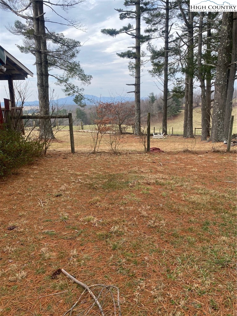1345 Wagoner Ridge Road Ennice, NC 28623 - Photo 21 of 48 a view of a yard with a tree