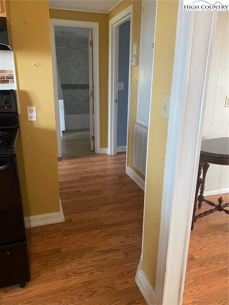 1345 Wagoner Ridge Road Ennice, NC 28623 - Photo 30 of 48 a view of a hallway with wooden floor and staircase