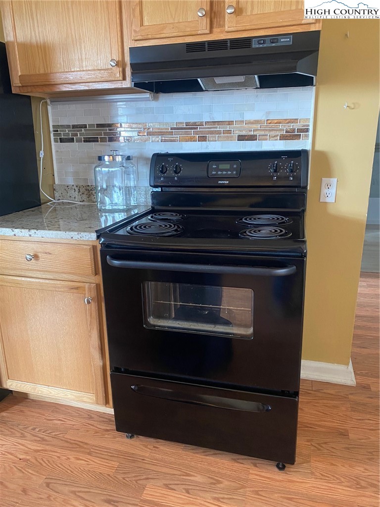 1345 Wagoner Ridge Road Ennice, NC 28623 - Photo 31 of 48 a stove top oven sitting inside of a kitchen