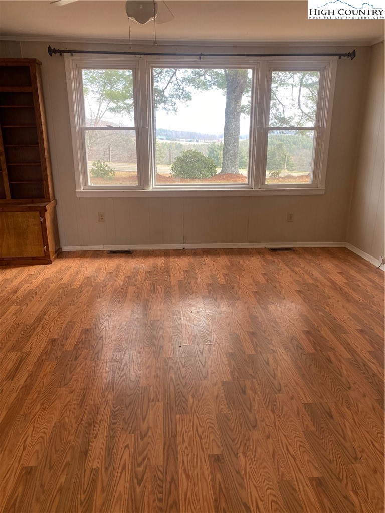 1345 Wagoner Ridge Road Ennice, NC 28623 - Photo 33 of 48 an empty room with wooden floor and windows
