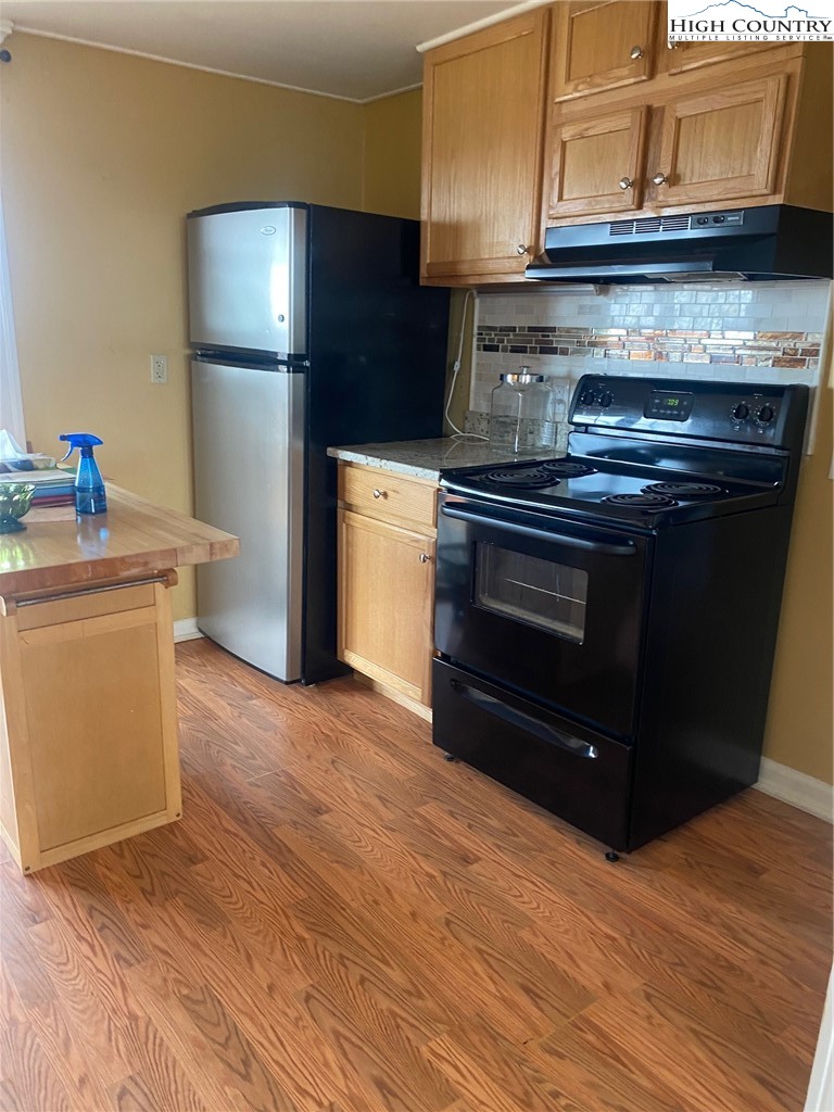1345 Wagoner Ridge Road Ennice, NC 28623 - Photo 34 of 48 a kitchen with a stove and a refrigerator