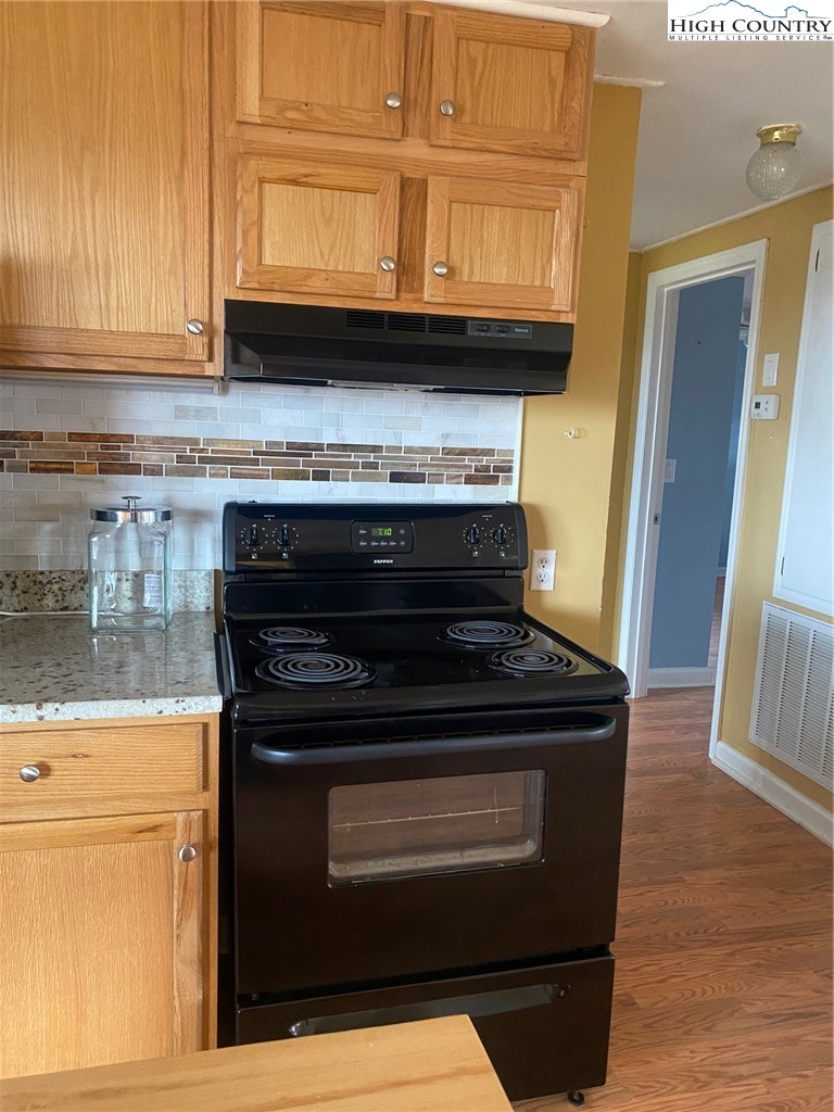 1345 Wagoner Ridge Road Ennice, NC 28623 - Photo 38 of 48 a stove top oven sitting inside of a kitchen