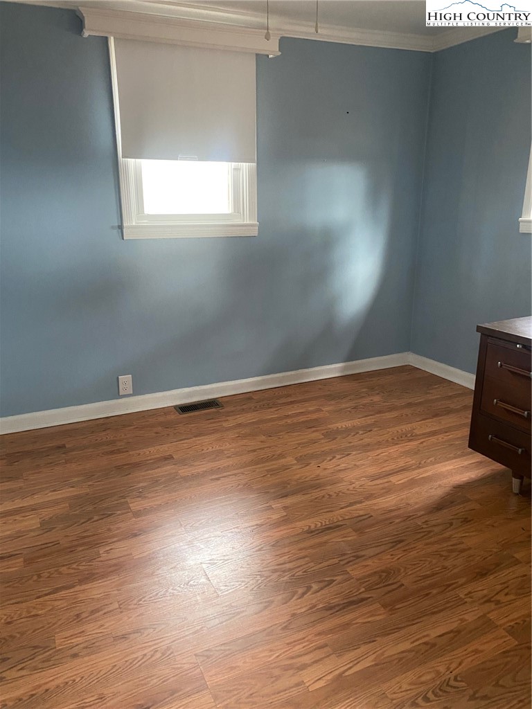 1345 Wagoner Ridge Road Ennice, NC 28623 - Photo 40 of 48 a view of an empty room with wooden floor and a window