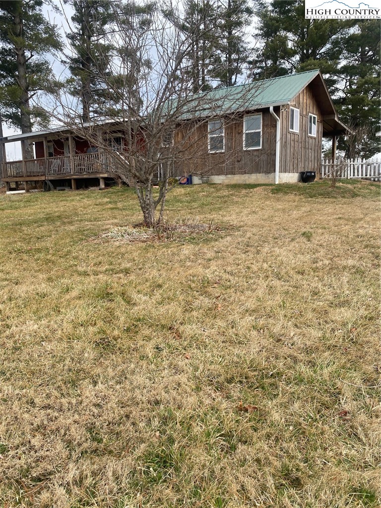 1345 Wagoner Ridge Road Ennice, NC 28623 - Photo 48 of 48 a view of a yard in front of a house with large tree